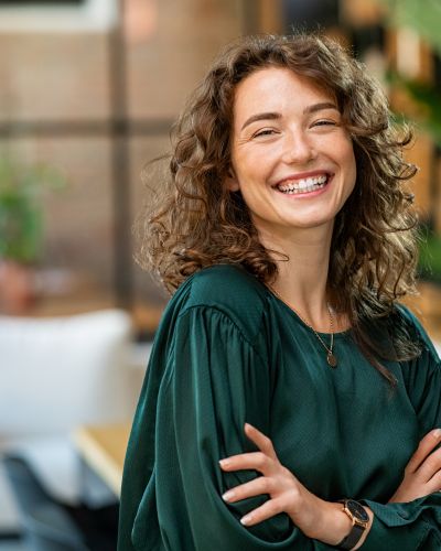 Beautiful woman smiling with crossed arms