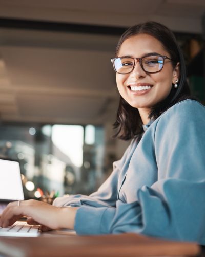 Space, computer and portrait of woman in office at night, working and research idea with mockup screen. Mock up, happy and businesswoman search online for creative design, inspiration and ppt review