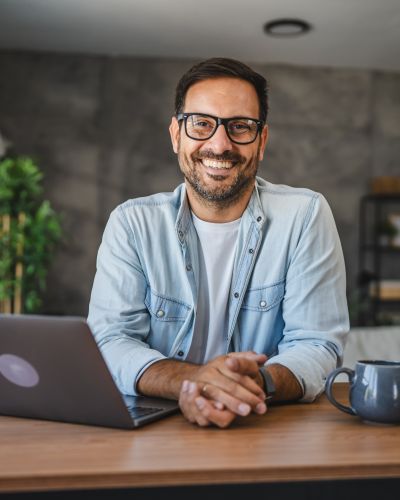 Portrait of adult happy caucasian man stand and smile at home